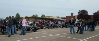 line up of motorcycles and members at event